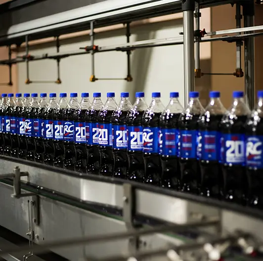 RC Cola bottles in motion through bottling plant