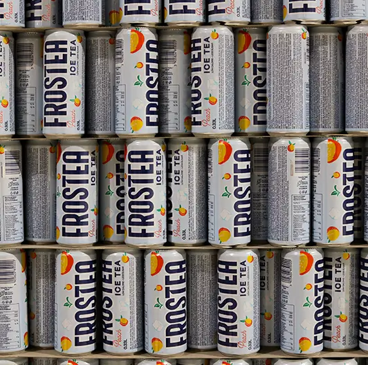 Frostea cans stacked vertically in warehouse