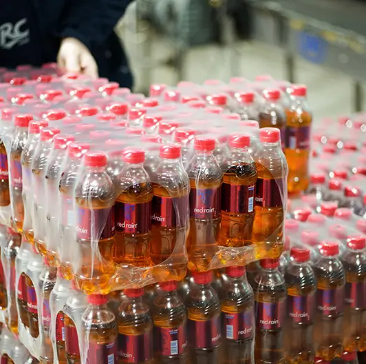 Shrink-wrapped Red Rain bottles prepared for distribution